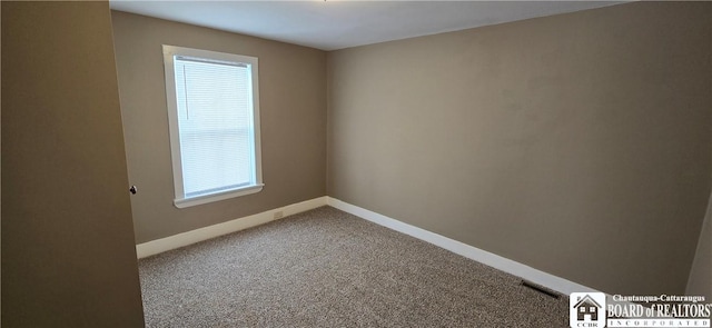 empty room featuring carpet, visible vents, and baseboards