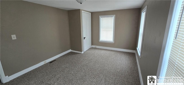 unfurnished bedroom featuring carpet floors, visible vents, and baseboards