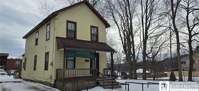 view of front of house with roof with shingles