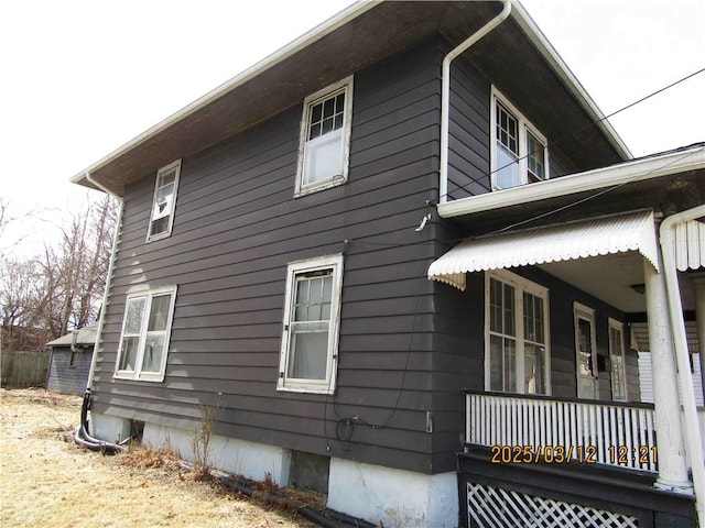 view of side of home with a porch