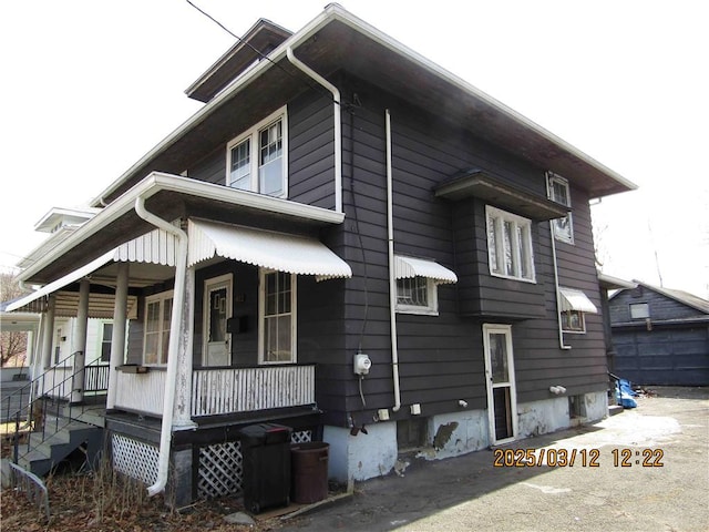 view of side of property with covered porch