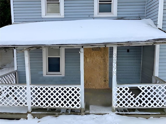 view of snow covered property entrance