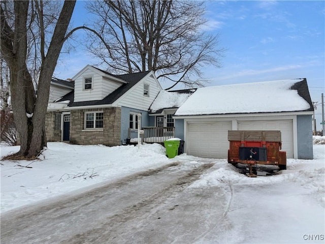 view of front of home featuring a garage and stone siding