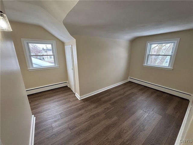 bonus room with a wealth of natural light, a baseboard radiator, and dark wood finished floors