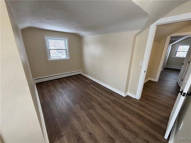 unfurnished room featuring dark wood-style floors, a baseboard radiator, a healthy amount of sunlight, and baseboard heating