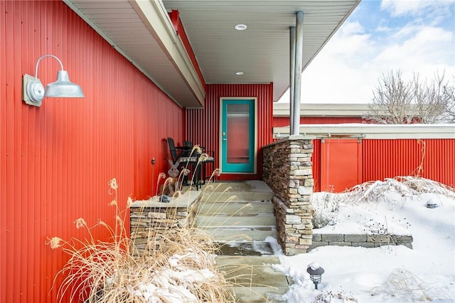 view of snow covered property entrance