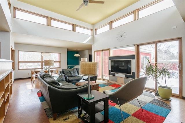 living room with a high ceiling and a ceiling fan