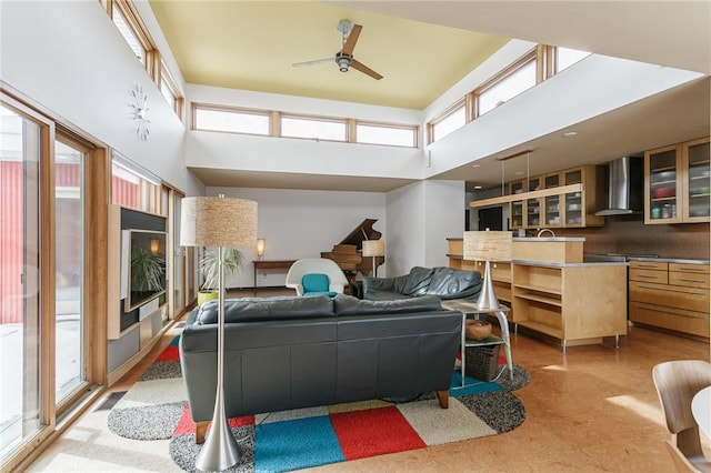 interior space featuring a ceiling fan and a towering ceiling