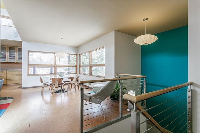 interior space featuring baseboards, a wealth of natural light, and tile patterned floors