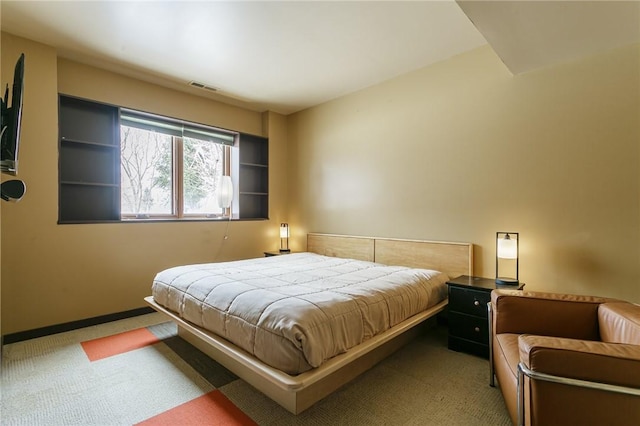 carpeted bedroom featuring visible vents and baseboards