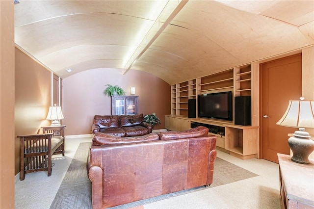 living room featuring baseboards, vaulted ceiling, and carpet flooring