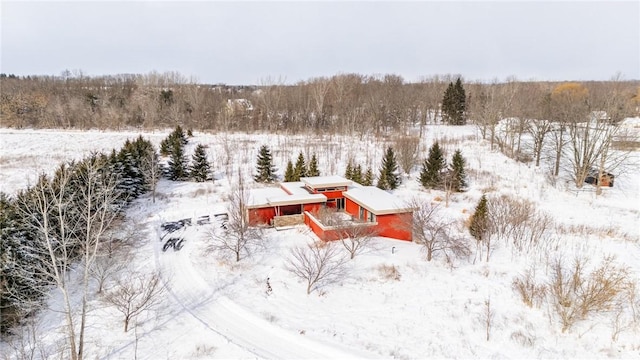 snowy aerial view with a forest view