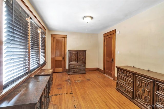 interior space featuring light wood-style flooring and baseboards