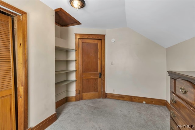 bonus room with light carpet, lofted ceiling, and baseboards