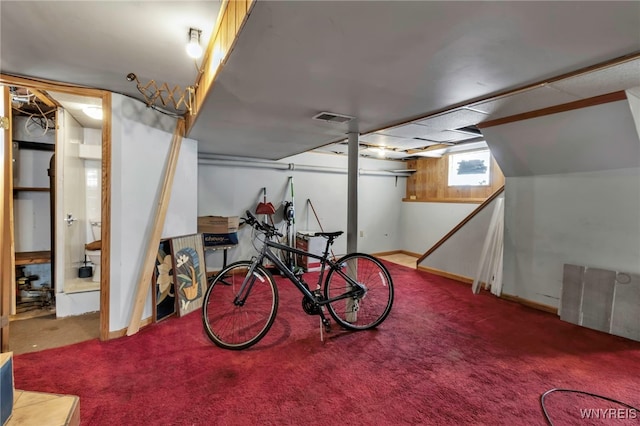 basement with carpet, visible vents, and baseboards