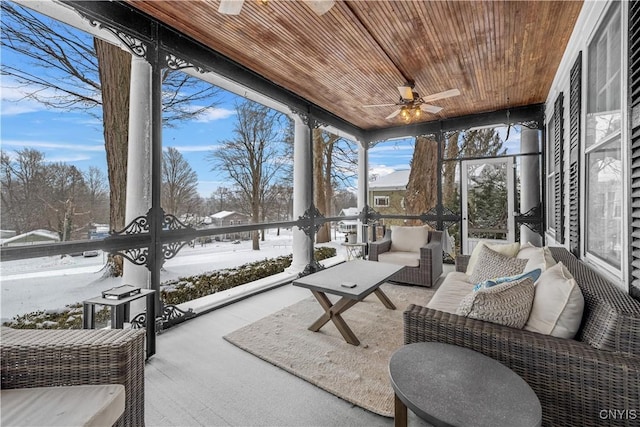 sunroom / solarium featuring wooden ceiling and a ceiling fan