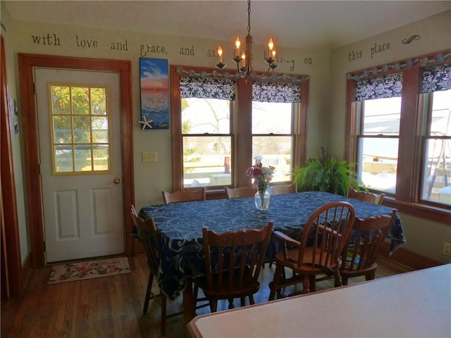 dining space featuring a notable chandelier and wood finished floors