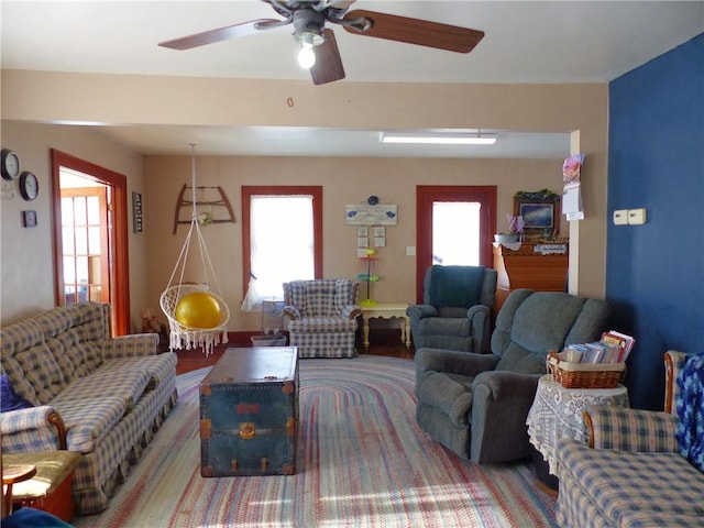 living area featuring a ceiling fan and a wealth of natural light