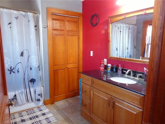 bathroom featuring tile patterned flooring, a closet, and vanity