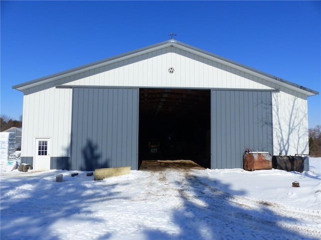 snow covered garage with a garage