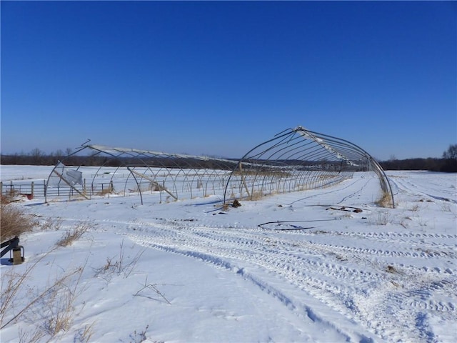 snowy yard featuring a rural view