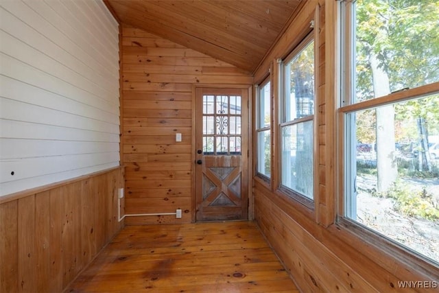 unfurnished sunroom with lofted ceiling, plenty of natural light, and wooden ceiling