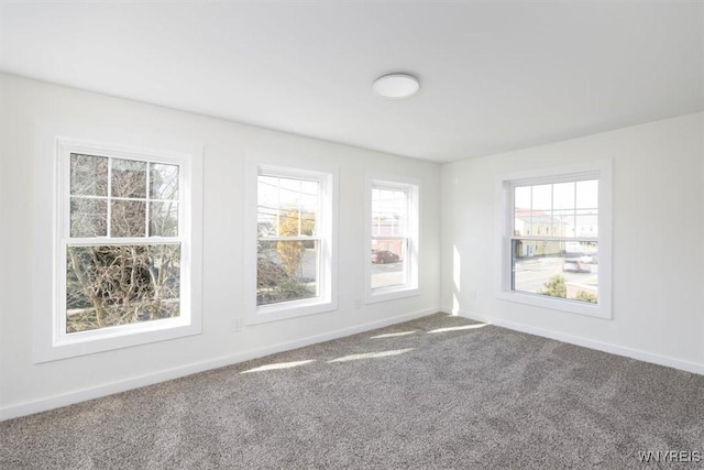 carpeted spare room with baseboards