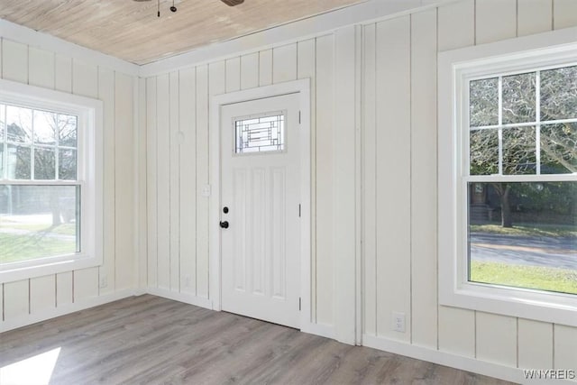 entryway featuring light wood-type flooring, wood ceiling, and ceiling fan