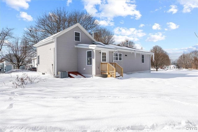 snow covered property featuring central air condition unit