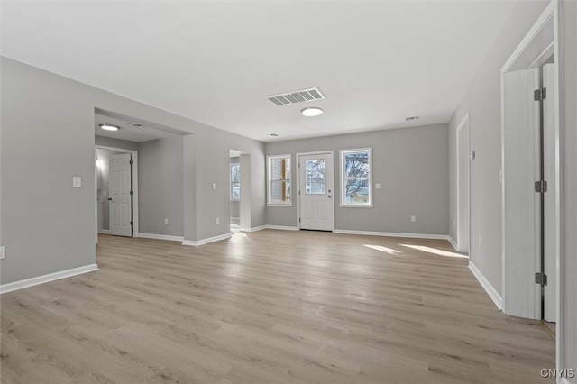 entryway with light wood-type flooring, visible vents, and baseboards