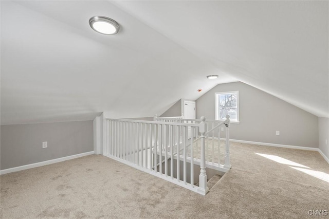 bonus room with lofted ceiling, carpet flooring, and baseboards