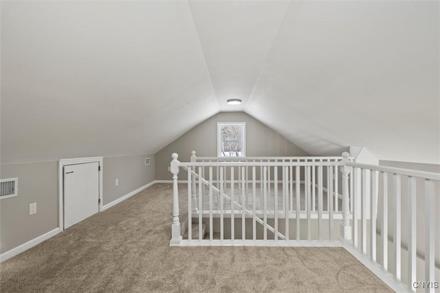 bonus room with carpet, visible vents, baseboards, and vaulted ceiling