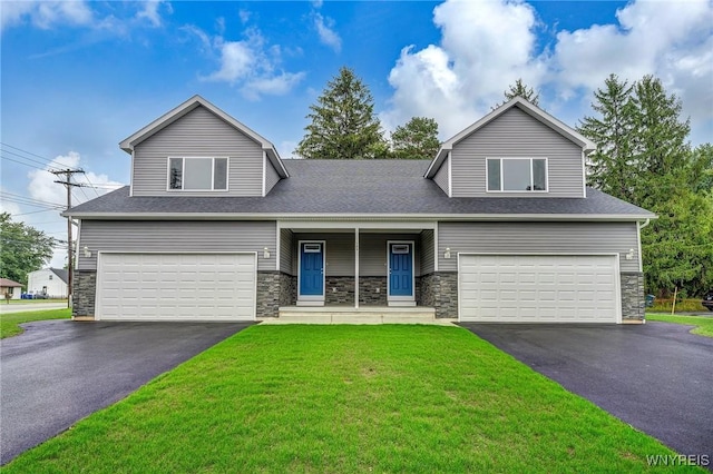 view of front of house with a garage, stone siding, driveway, and a front yard