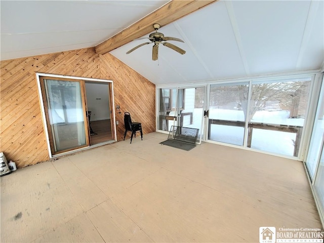 unfurnished sunroom with vaulted ceiling with beams and a ceiling fan