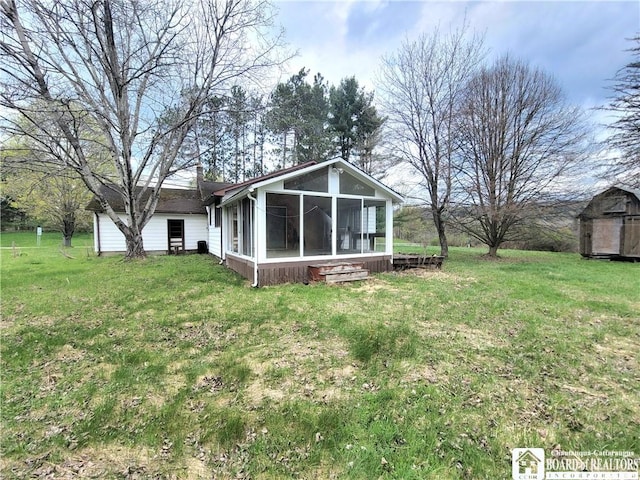 5185 Rte 474, Harmony, NY 14710 - back of house featuring a storage shed, a yard, an outbuilding, and a sunroom
