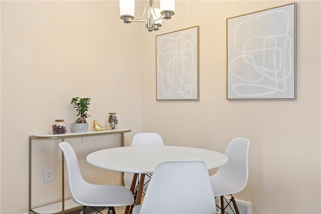 dining room with a chandelier and visible vents