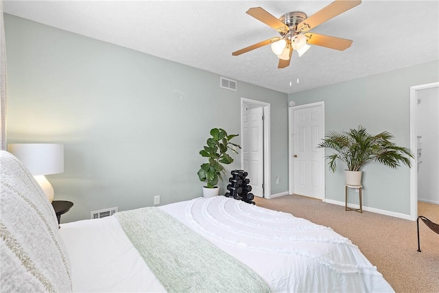 bedroom with light colored carpet, visible vents, ceiling fan, and baseboards