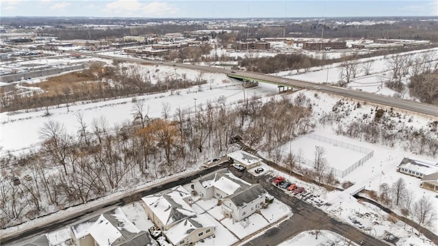 snowy aerial view with a residential view