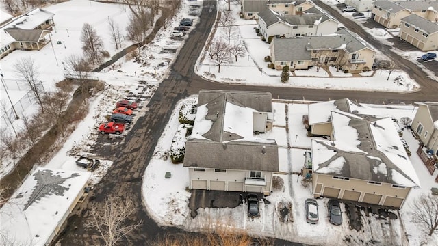 snowy aerial view featuring a residential view