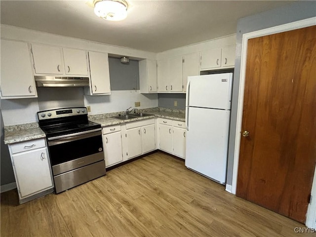 kitchen with white cabinets, light wood-style flooring, freestanding refrigerator, stainless steel range with electric cooktop, and under cabinet range hood