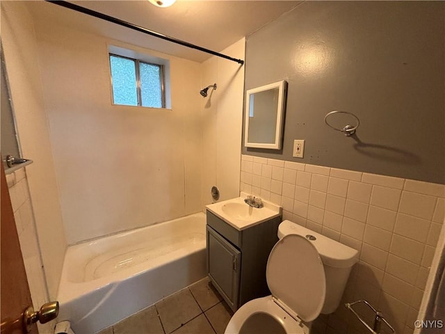 full bath featuring bathtub / shower combination, toilet, tile patterned flooring, vanity, and tile walls