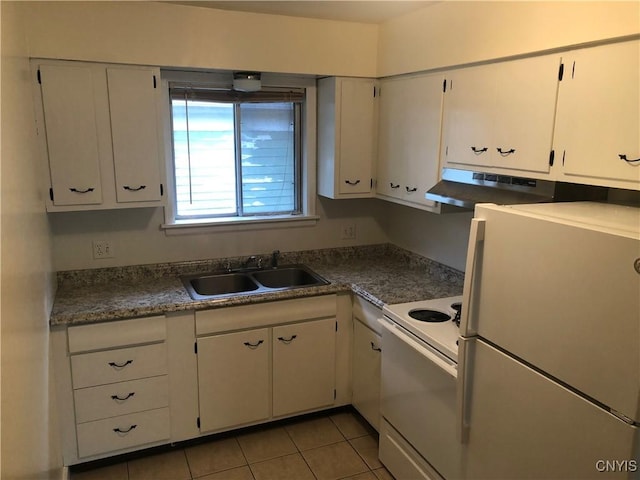 kitchen featuring white appliances, a sink, white cabinets, and under cabinet range hood