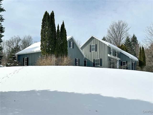 view of snow covered exterior featuring board and batten siding