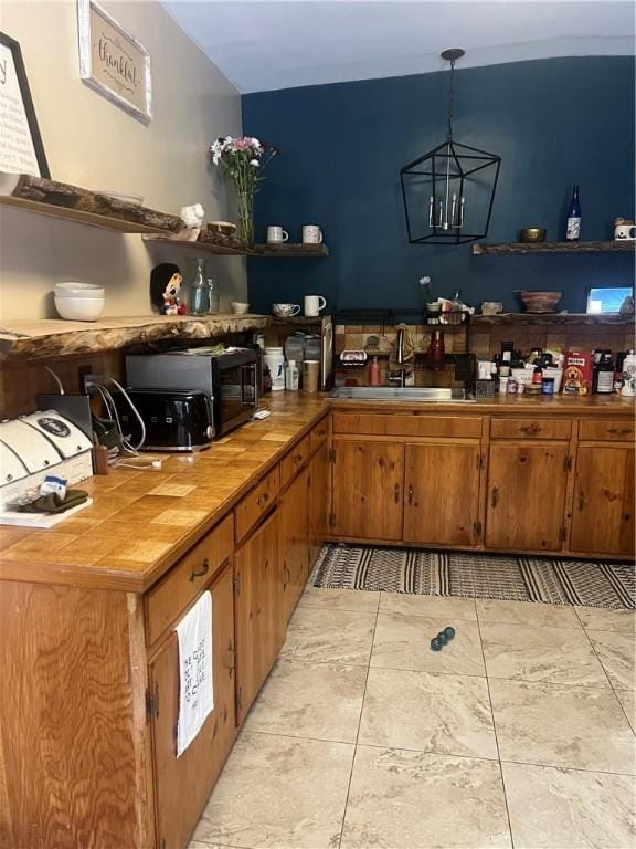 bar with decorative light fixtures and a sink