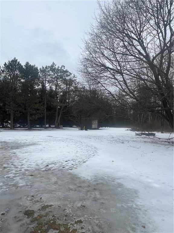 snowy yard with a garage