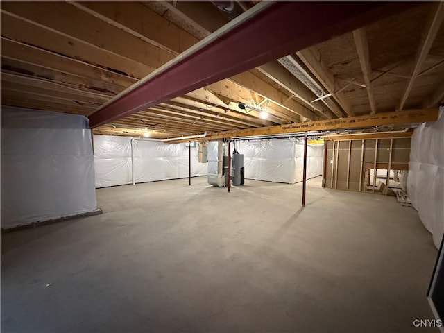 unfinished basement featuring water heater