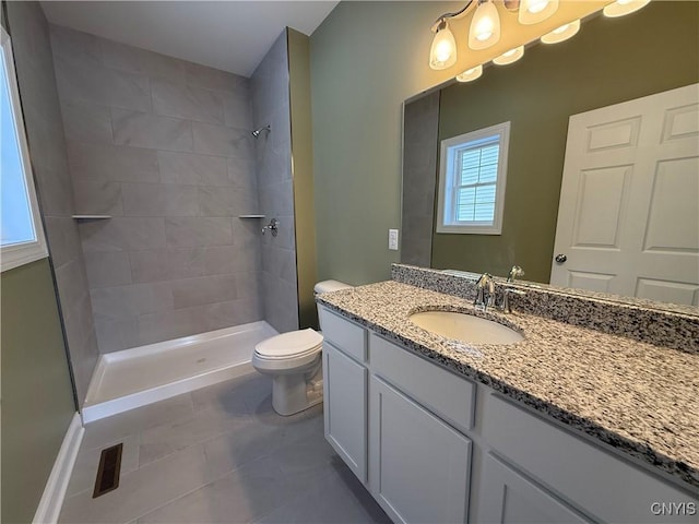 bathroom with a shower stall, visible vents, vanity, and toilet