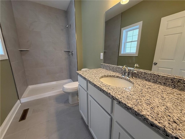 full bath with a shower stall, vanity, toilet, and tile patterned floors