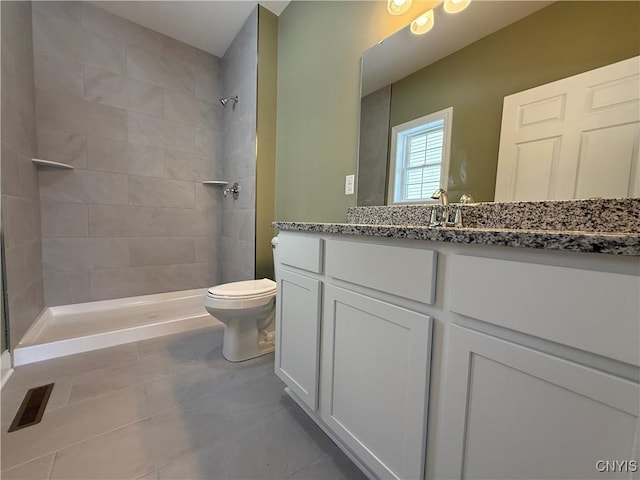 full bathroom featuring toilet, visible vents, a stall shower, and vanity