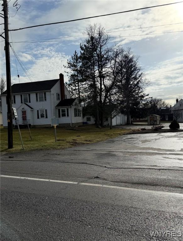 1475 Orchard Park Rd, West Seneca, NY 14224 - view of front of home featuring a chimney and a front yard